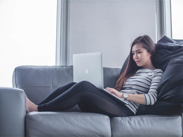 Woman using a laptop on the couch