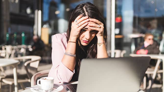 A woman worrying about what to do when her email is hacked